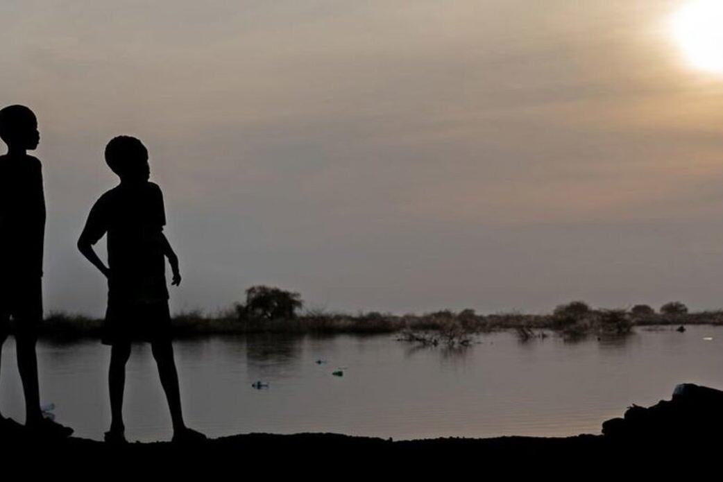 Two silhouettes at sunset.