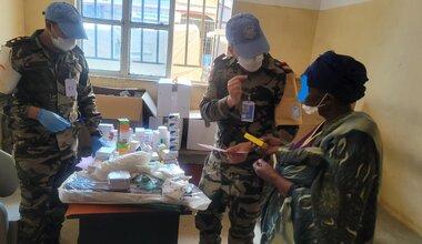 Des professionnels de la santé se tiennent à côté d'équipements médicaux.